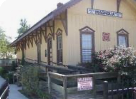 Historic train depot in Magnolia, Texas, highlighting the charm of the area’s neighborhoods and homes for sale.
