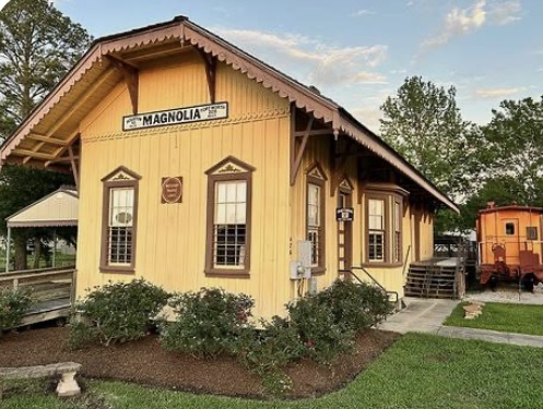 Historic Magnolia Depot building in Magnolia, Texas, showcasing local heritage and nearby real estate opportunities for buyers and sellers