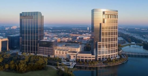 Aerial view of The Woodlands, Texas business district with modern high-rise buildings near the water — ideal for real estate buyers and sellers looking for luxury living
