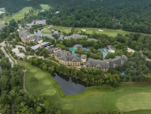 The Woodlands Resort with pools, golf greens, and forest surroundings — demonstrating the premium lifestyle offered in local real estate
