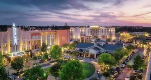 Aerial view of The Woodlands, Texas at sunset with shops, restaurants, and luxury residence