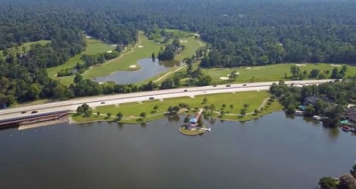 Scenic overhead view of Lake Woodlands with golf course, waterfront homes, and lush greenery, a top location for homebuyer