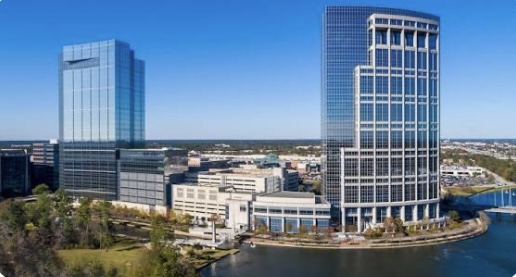Skyline of The Woodlands, Texas with modern waterfront towers showcasing a thriving real estate and business district